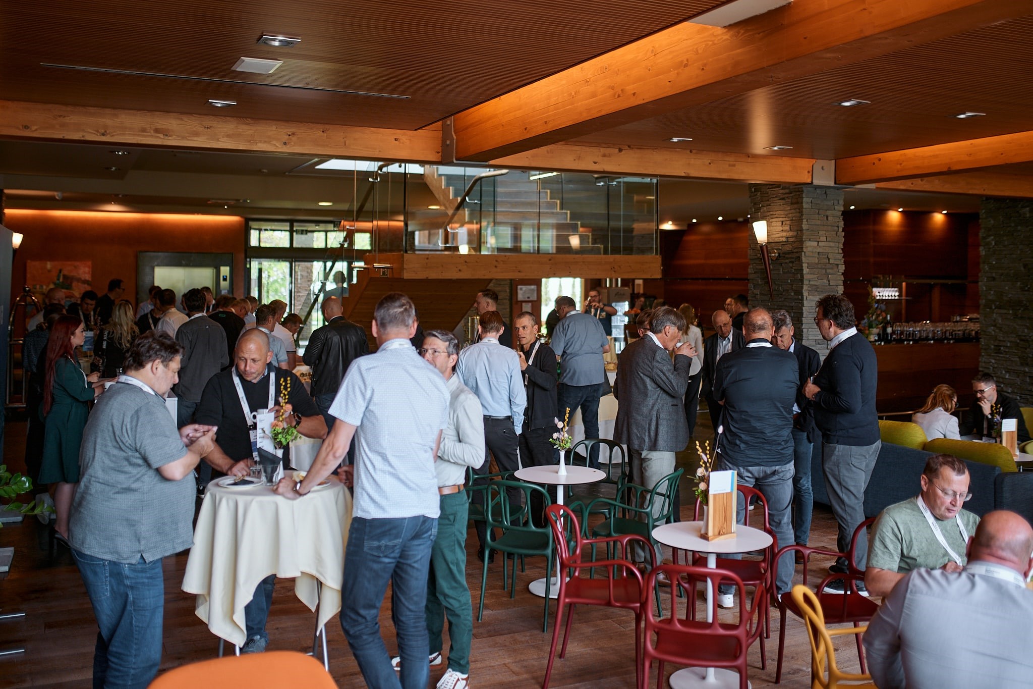 Attendees at a hi tech event are seen networking during a break in the event