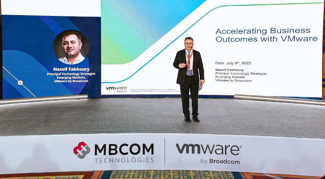a man presents on a stage at a hi-tech event