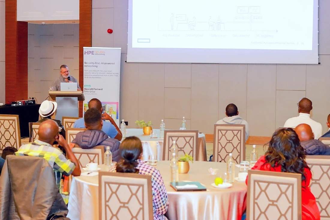 a man presents to an audience at a hi-tech event