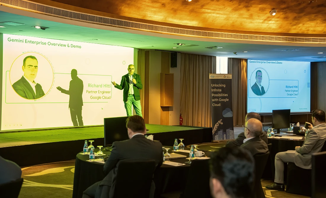 A man presents to a roomful of people at a hi tech event