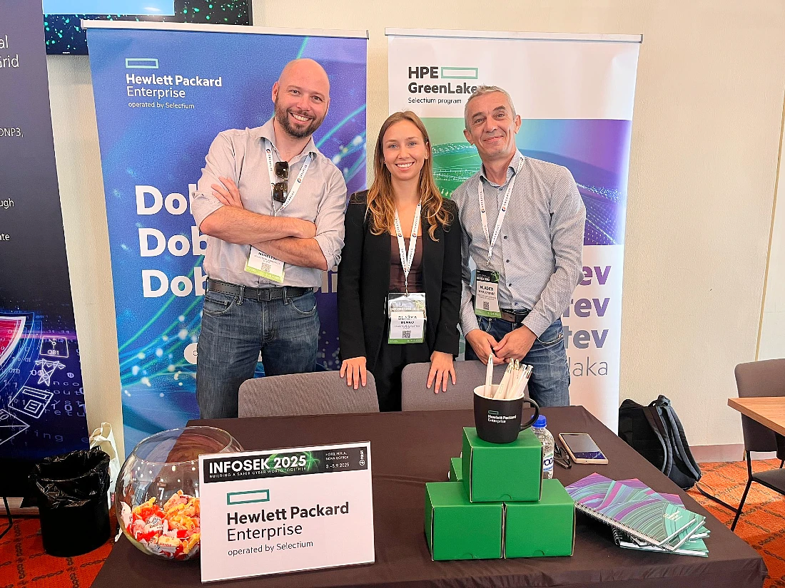 three people are seen in a group photo at a hi tech event