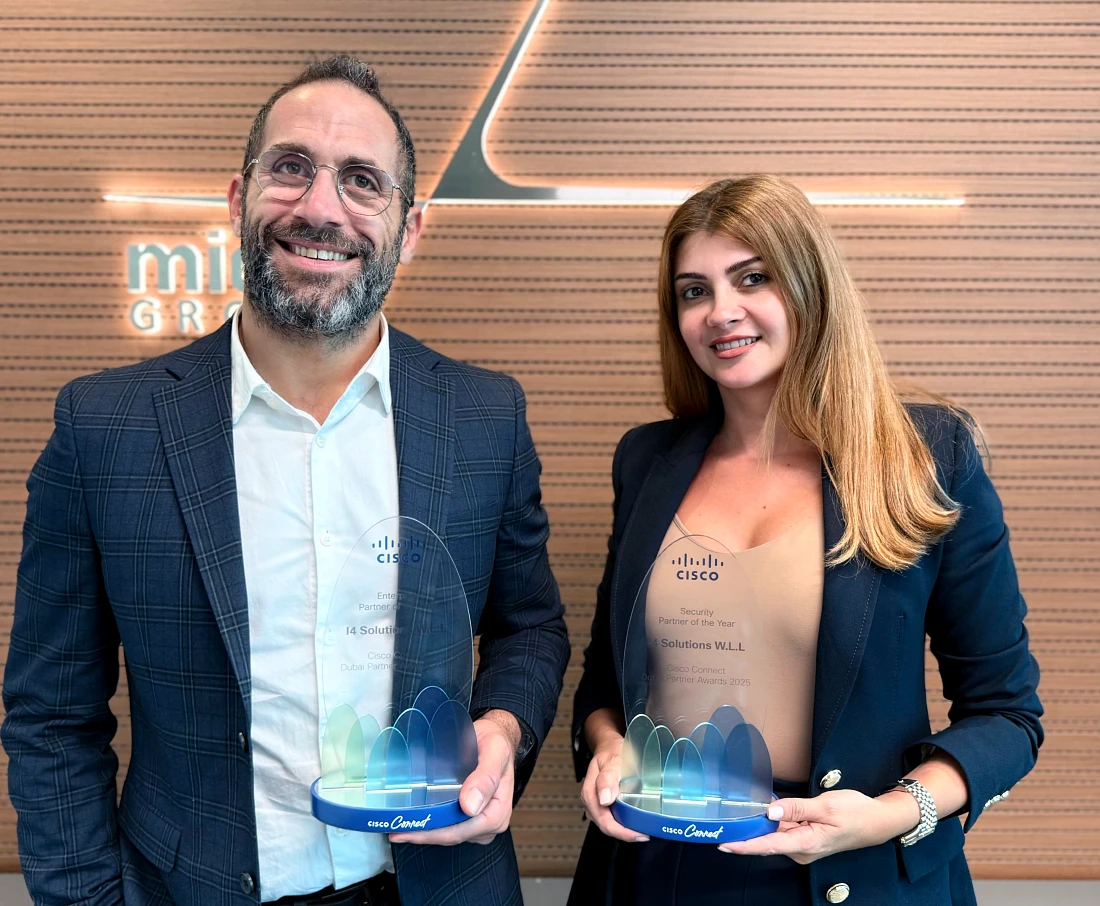 A man and a woman are seen with both holding glass trophies