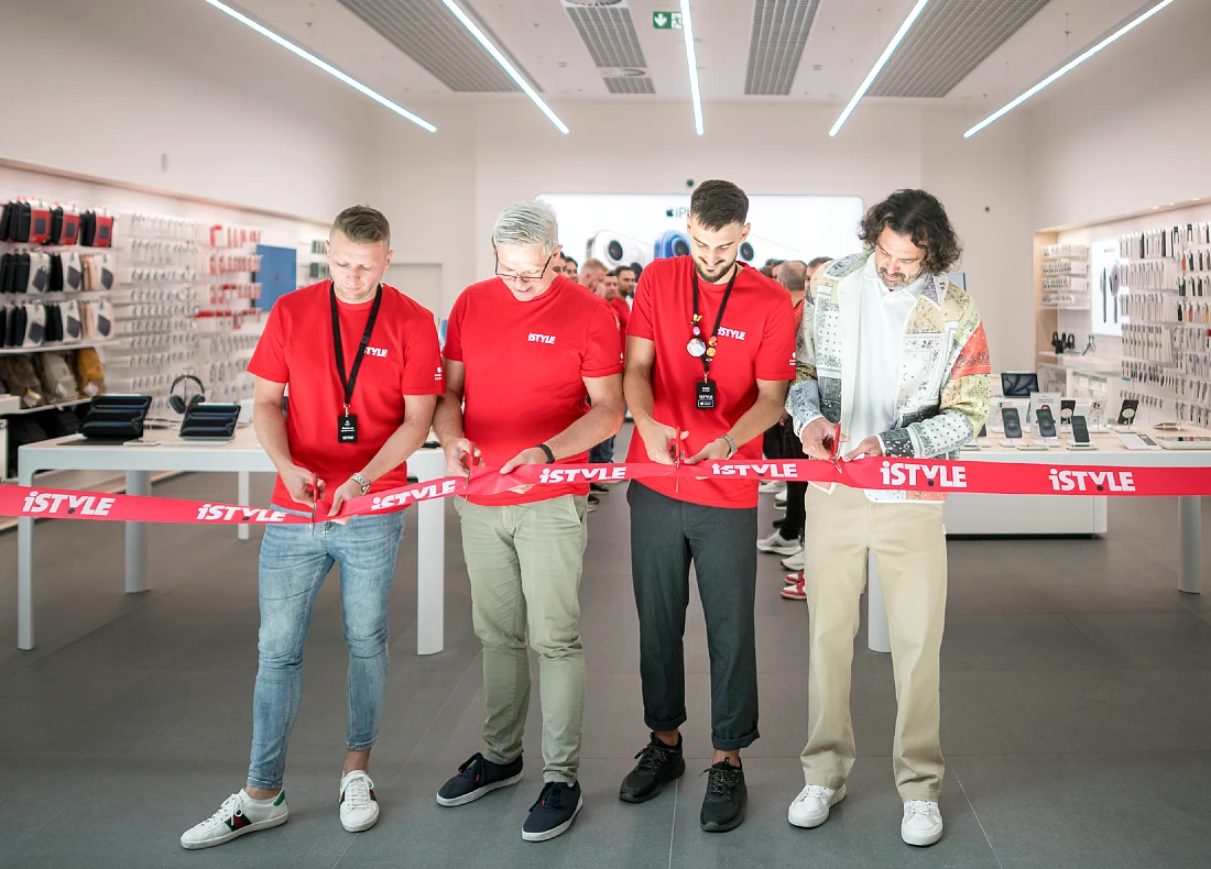 Four men are seen cutting a red tape to open a hi-tech retail outlet