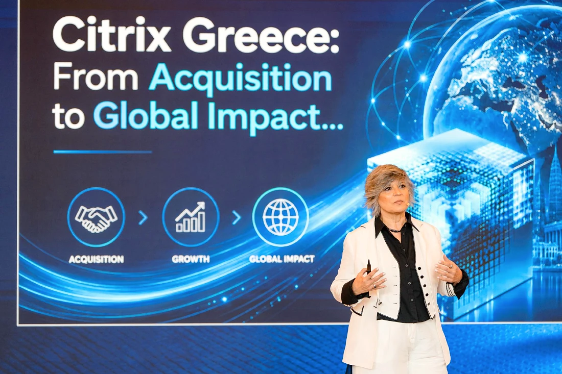 A woman is presenting in front of a digital screen