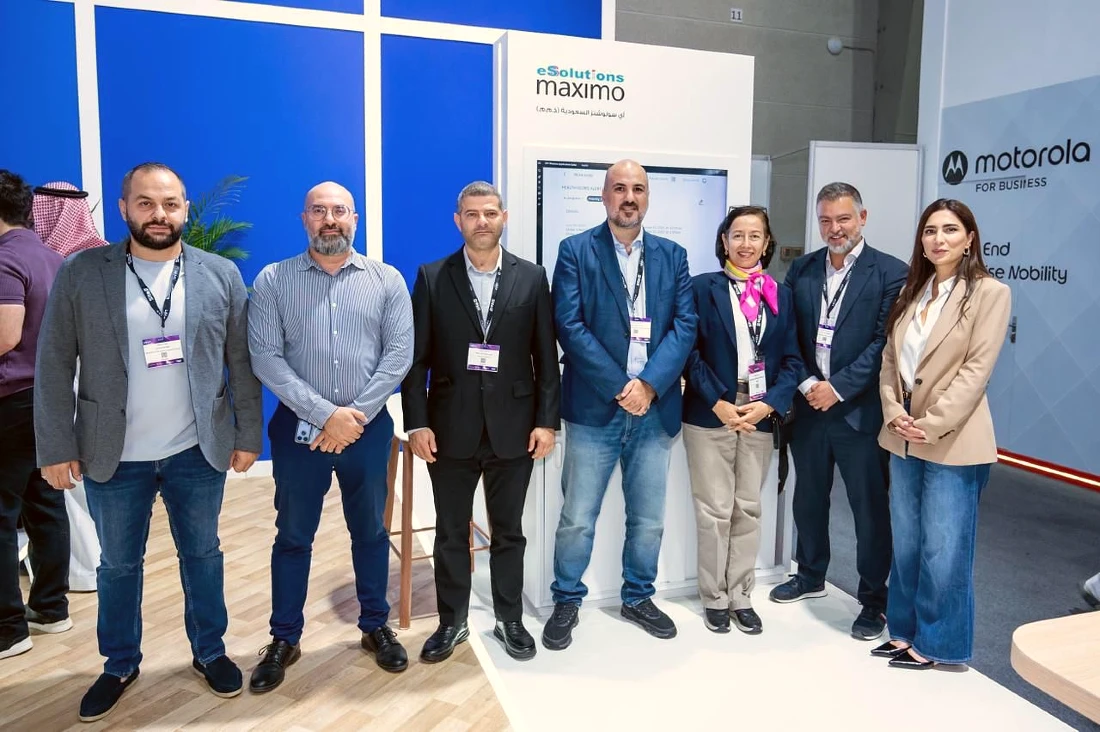 Seven people seen in a group photograph at a hi tech event